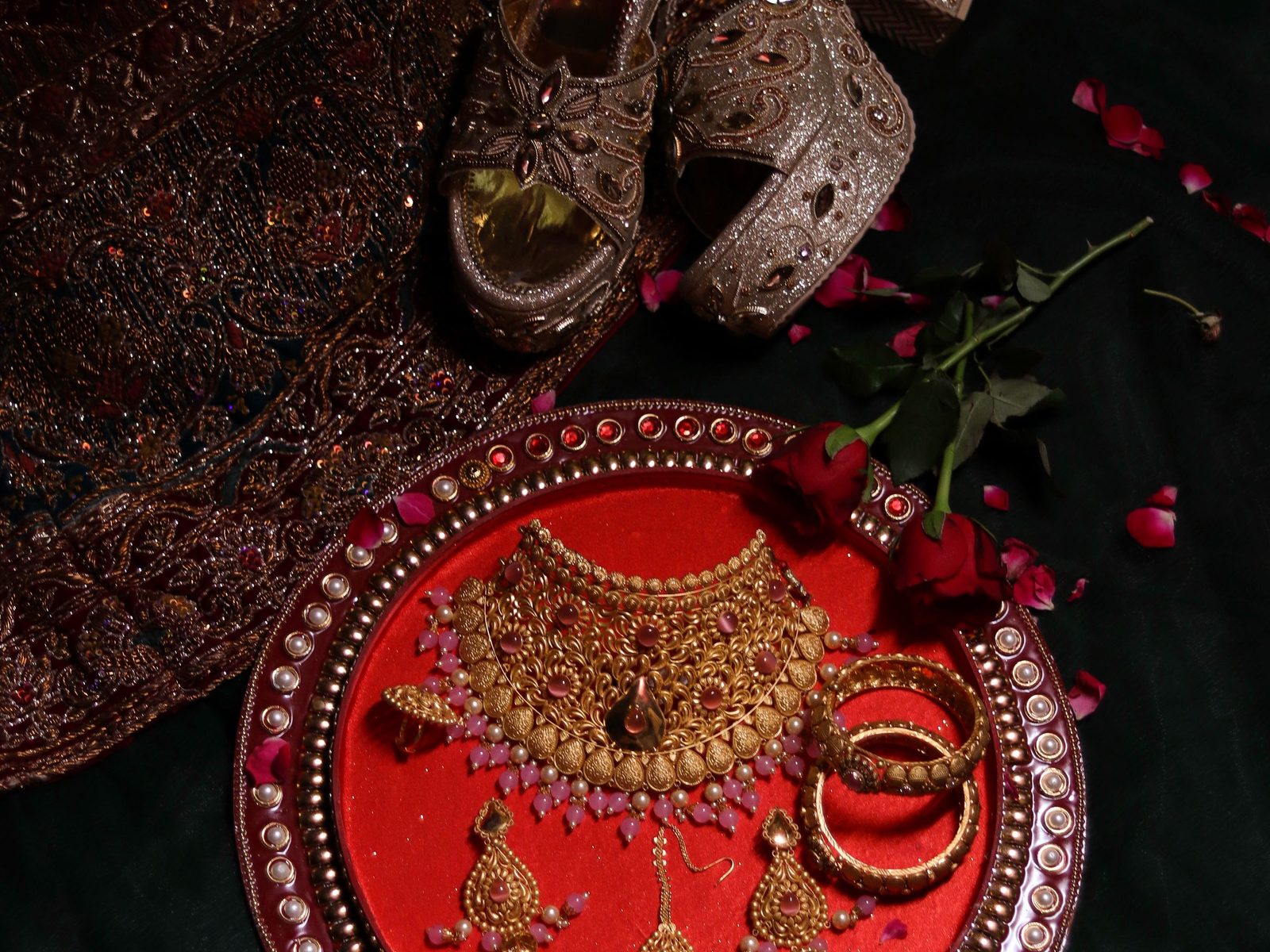 Traditional bridal gold jewellery on a red saree