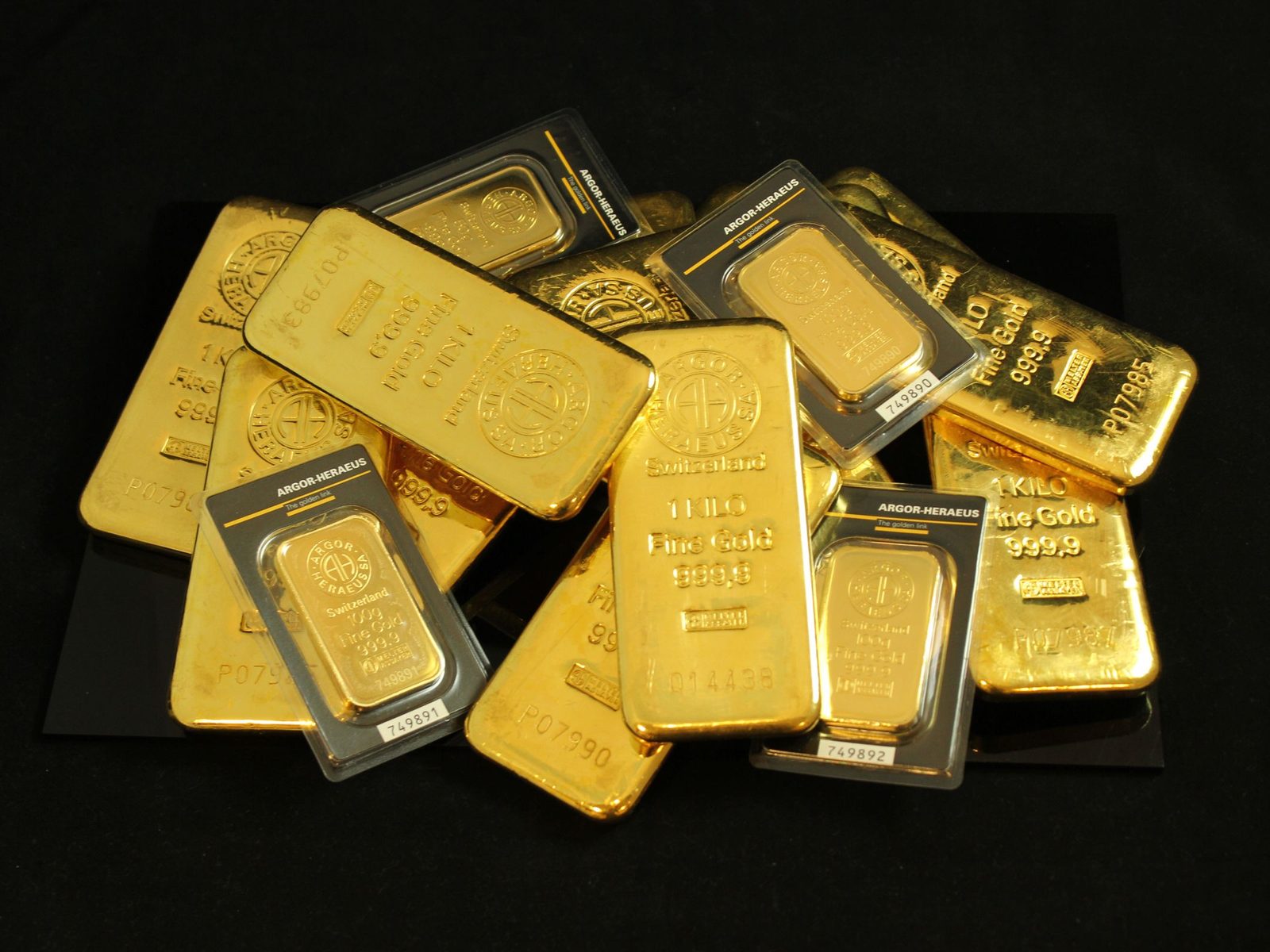 Fine gold bars stacked in low light