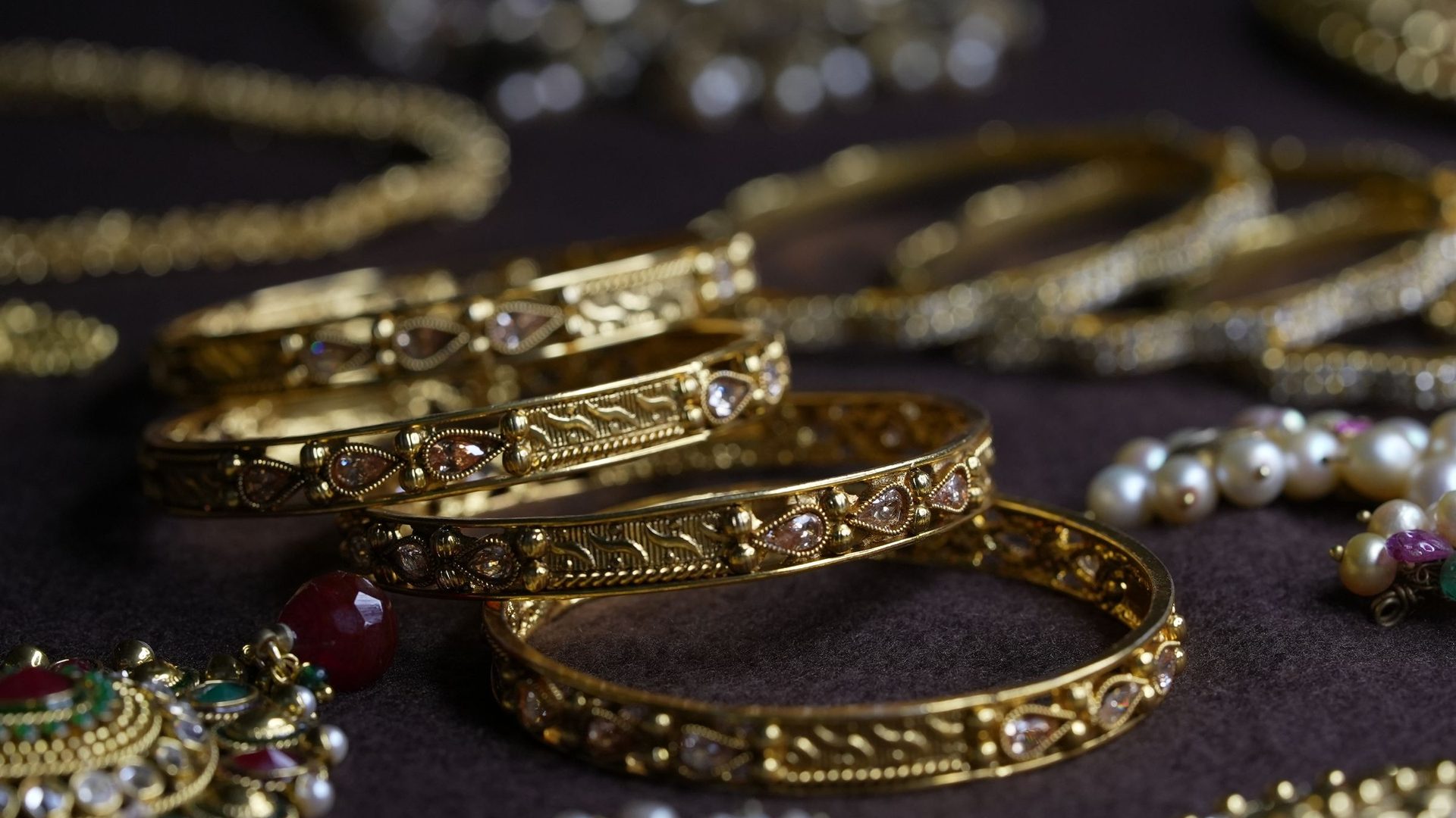 Gold bangles and traditional jewellery laid out on display